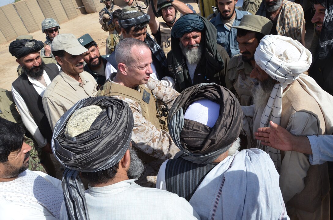 Gen. John Allen, the commanding general of International Security Assistance Force, talks with Marjah district officials during his first visit to the district, Aug. 4. Allen succeeded Gen. David Petraeus as the ISAF commander.